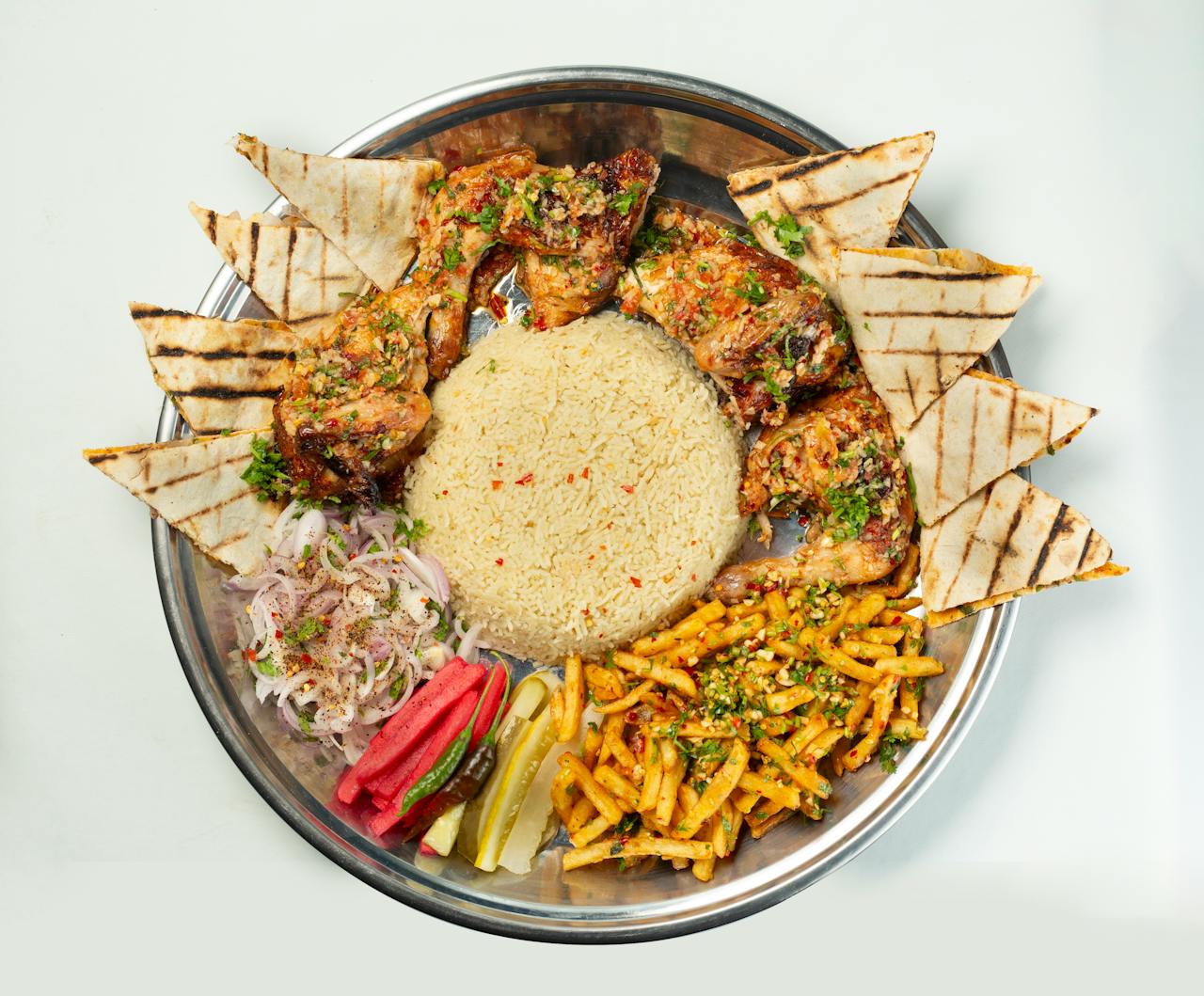 about-01 A delicious Bangladeshi platter featuring grilled chicken, rice, flatbread, and garnishes.