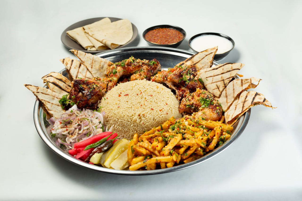 our-services-3 Appetizing Bangladeshi meal featuring grilled chicken, rice, and flatbread on a white backdrop.