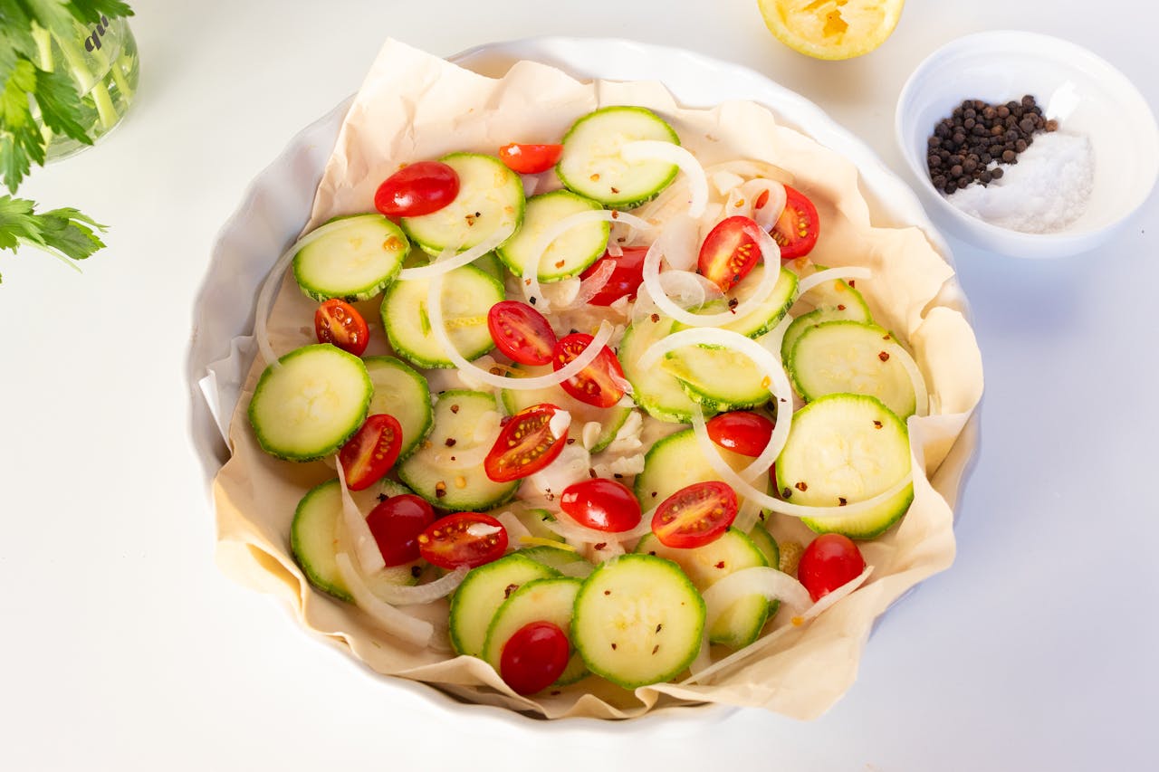 gallery-2 A delicious and colorful vegetable tart featuring cherry tomatoes, zucchini, and onions.